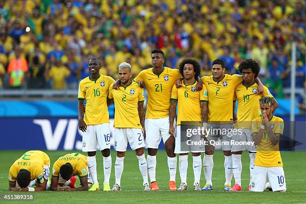 Thiago Silva, Luiz Gustavo, Ramires, Dani Alves, Jo, Marcelo, Hulk, Willian and Neymar of Brazil look on during a penalty shootout during the 2014...