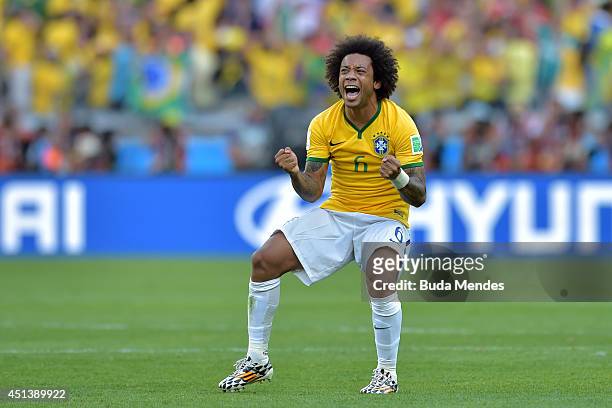 Marcelo of Brazil celebrates after defeating Chile in a penalty shootout during the 2014 FIFA World Cup Brazil round of 16 match between Brazil and...