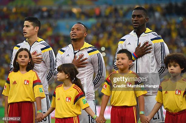 James Rodriguez, Juan Camilo Zuniga and Jackson Martinez of Colombia sing the National Anthem prior to the 2014 FIFA World Cup Brazil round of 16...