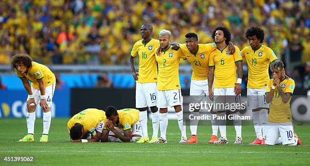 David Luiz, Thiago Silva, Luiz Gustavo, Ramires, Dani Alves, Jo, Marcelo, Hulk, Willian and Neymar of Brazil look on during a penalty shootout during...