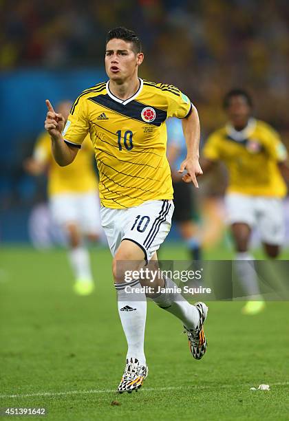James Rodriguez of Colombia celebrates scoring his team's first goal during the 2014 FIFA World Cup Brazil round of 16 match between Colombia and...