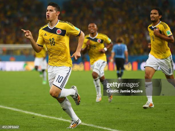 James Rodriguez of Colombia celebrates scoring his team's first goal during the 2014 FIFA World Cup Brazil round of 16 match between Colombia and...