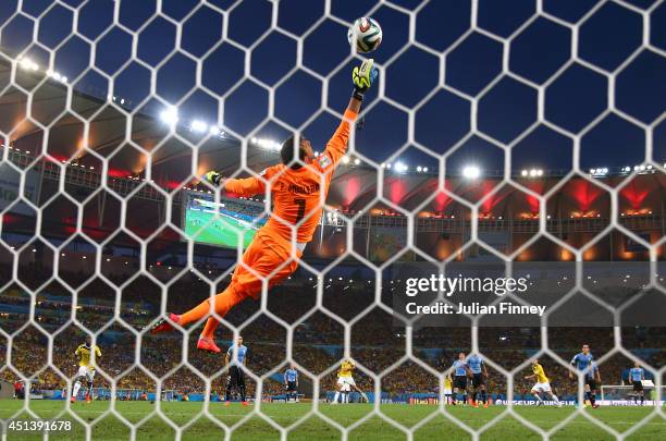 James Rodriguez of Colombia scores his team's first goal past Fernando Muslera of Uruguay during the 2014 FIFA World Cup Brazil round of 16 match...