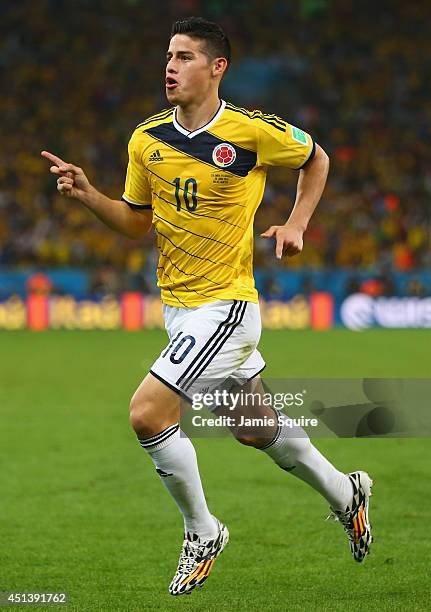 James Rodriguez of Colombia celebrates scoring his team's first goal during the 2014 FIFA World Cup Brazil round of 16 match between Colombia and...