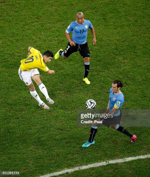 James Rodriguez of Colombia shoots and scores his team's first goal during the 2014 FIFA World Cup Brazil round of 16 match between Colombia and...