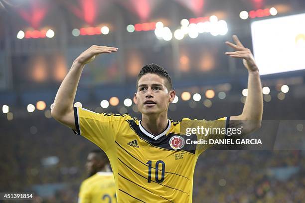 Colombia's midfielder James Rodriguez celebrates after scoring during the Round of 16 football match between Colombia and Uruguay at the Maracana...