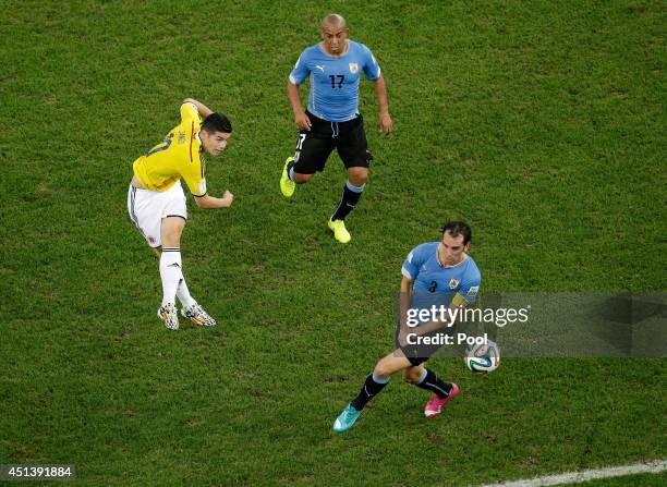 James Rodriguez of Colombia shoots and scores his team's first goal during the 2014 FIFA World Cup Brazil round of 16 match between Colombia and...