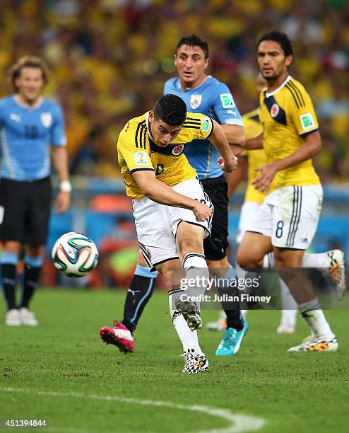 James Rodriguez of Colombia shoots and scoores his team's first goal during the 2014 FIFA World Cup Brazil round of 16 match between Colombia and...