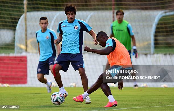 Costa Rica's midfielder Yeltsin Tejeda vies for the ball with Costa Rica's defender Waylon Francis during a training session at the Wilson Campos...