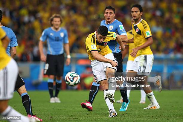 James Rodriguez of Colombia shoots and scoores his team's first goal during the 2014 FIFA World Cup Brazil round of 16 match between Colombia and...