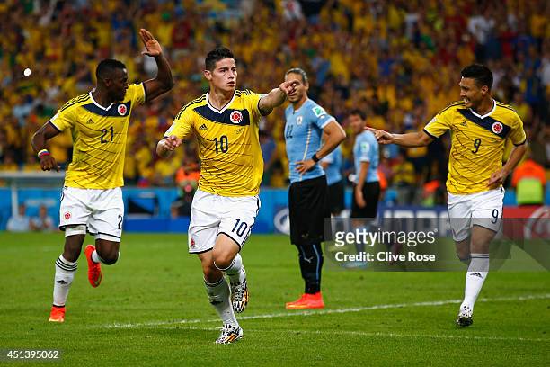 James Rodriguez of Colombia celebrates scoring his team's second goal and his second of the game with teammates Jackson Martinez and Teofilo...