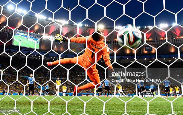 James Rodriguez of Colombia scores his team's first goal past Fernando Muslera of Uruguay during the 2014 FIFA World Cup Brazil Round of 16 match...