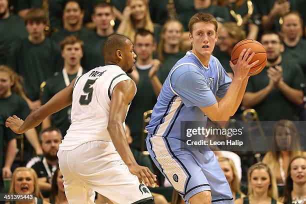 Cory Osetkowski of the Columbia Lions looks to drive the ball to the basket as Adreian Payne of the Michigan State Spartans defends during the second...