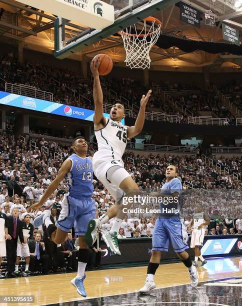 Denzel Valentine of the Michigan State Spartans drives the ball to the basket during the second half of the game against the Columbia Lions during...