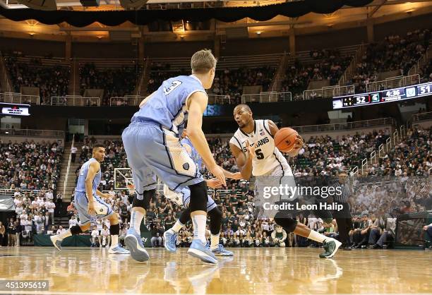 Adreian Payne of the Michigan State Spartans drives the ball to the basket as Grant Mullins of the Columbia Lions defends during the second half of...