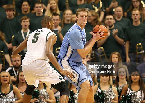 Cory Osetkowski of the Columbia Lions looks to drive the ball to the basket as Adreian Payne of the Michigan State Spartans defends during the second...