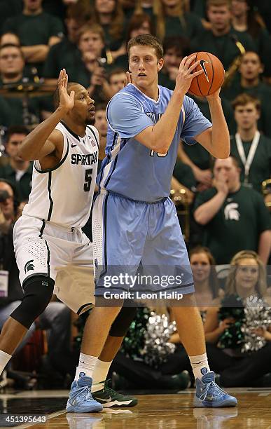 Cory Osetkowski of the Columbia Lions looks to drive the ball to the basket as Adreian Payne of the Michigan State Spartans defends during the second...