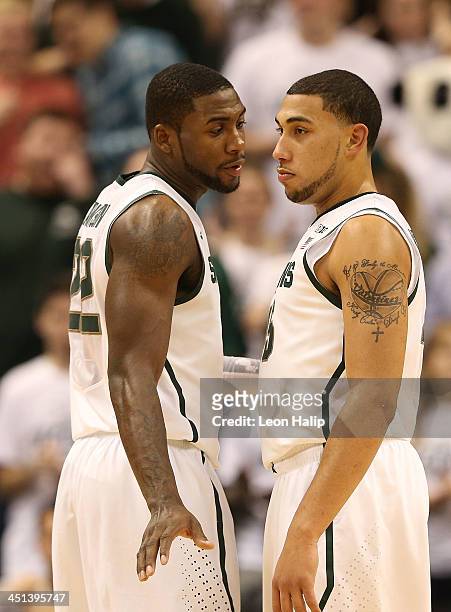 Branden Dawson of the Michigan State Spartans talks with teammate Denzel Valentine during the second half of the game against the Columbia Lions...