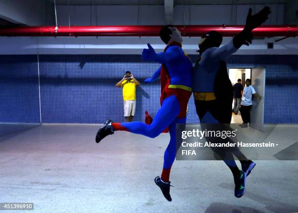 Supporters dressed as Superman and Batman celebrate at the stadium arena during the 2014 FIFA World Cup Brazil round of 16 match between Colombia and...