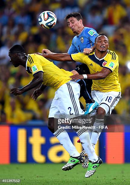 Cristian Rodriguez of Uruguay competes for the ball against Cristian Zapata and Juan Camilo Zuniga of Colombia during the 2014 FIFA World Cup Brazil...