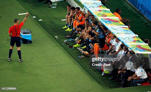 Diego Lugano of Uruguay is shown a yellow card while on the bench by referee Bjorn Kuipers during the 2014 FIFA World Cup Brazil round of 16 match...