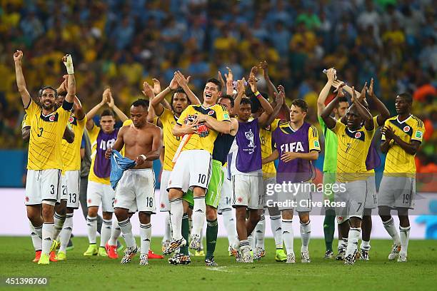 James Rodriguez of Colombia is picked up by goalkeeper David Ospina in celebration after defeating Uruguay 2-0 during the 2014 FIFA World Cup Brazil...