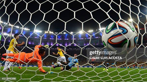 Uruguay's goalkeeper Fernando Muslera fails to save Colombia's midfielder James Rodriguez' second goal during the Round of 16 football match between...
