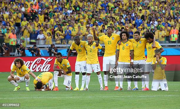 David Luiz, Thiago Silva, Luiz Gustavo, Ramires, Dani Alves, Jo, Marcelo, Hulk, Willian and Neymar of Brazil look on during the penalty shootout of...