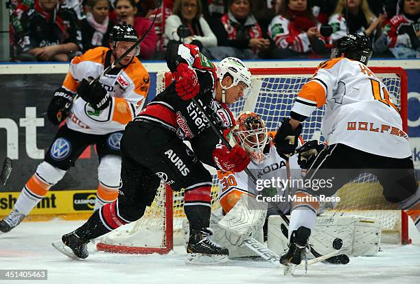 Andreas Falk of Koeln fails to score over Daniar Dshunussow , goaltender of Wolfsburg during the DEL match between Koelner Haie and Grizzly Adams...