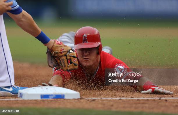 Mike Trout of the Los Angeles Angels of Anaheim is tagged out by Danny Valencia of the Kansas City Royals as he tries to advance to third on a Albert...