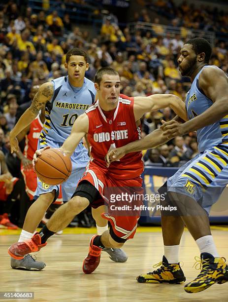 Aaron Craft of the Ohio State Buckeyes drives against Davante Gardner of the Marquette Golden Eagles during a basketball game at BMO Harris Bradley...