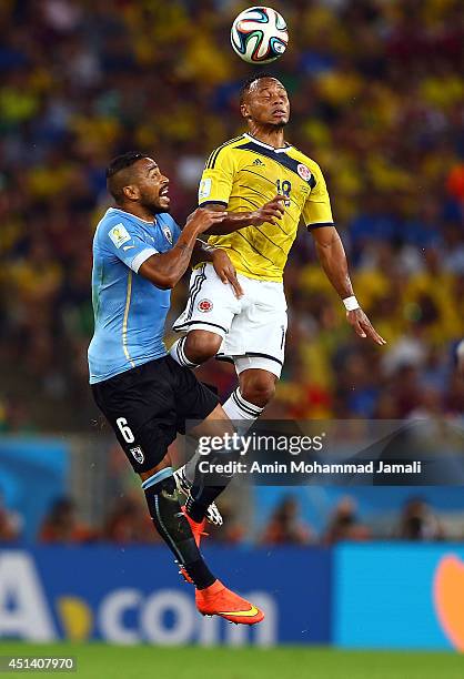 Juan Zuniga of Colombia in action against Alvaro Pereira of Uruguay during the 2014 FIFA World Cup Brazil round of 16 match between Colombia and...