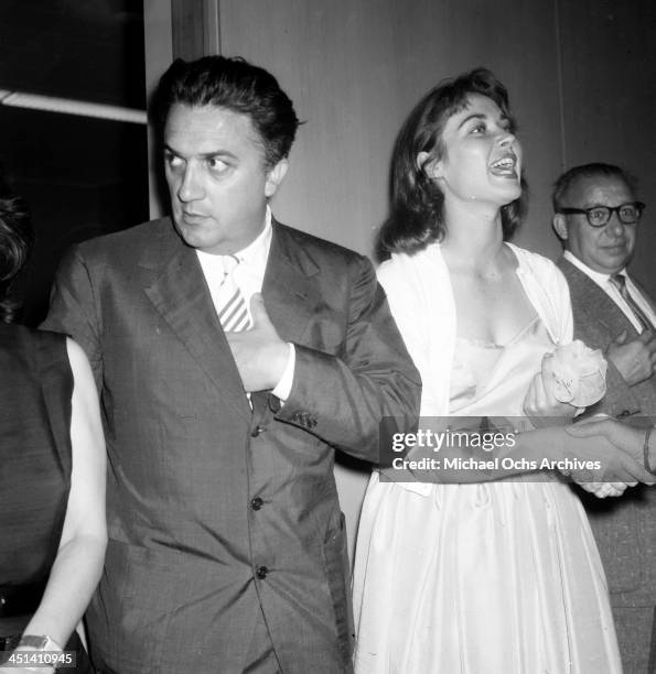 Director Federico Fellini and Gia Scala at his cocktail party in Los Angeles, California.