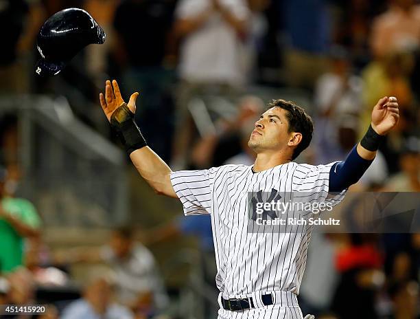 Jacoby Ellsbury of the New York Yankees reacts by throwing his helmet in the air after finding out the the run he scored on a stolen base and a two...