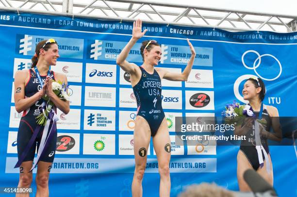 Helen Jenkins of Great Britain, Gwen Jorgensen of the United States and Juri Ide of Japan celebrate their wins at the Elite Women's race in the 2014...