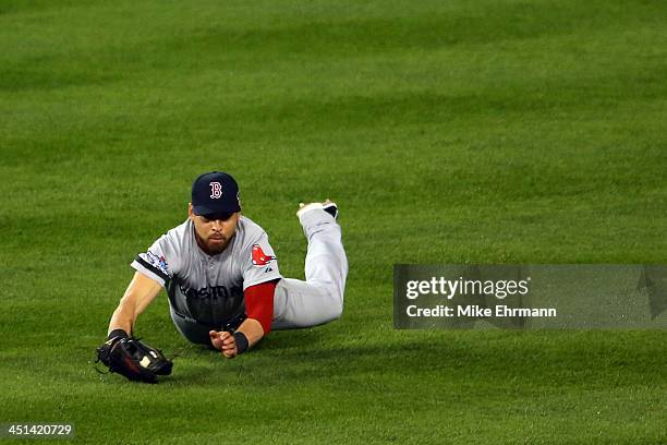 Jacoby Ellsbury of the Boston Red Sox catches a ball hit by Omar Infante of the Detroit Tigers for an out in the second inning against the Detroit...