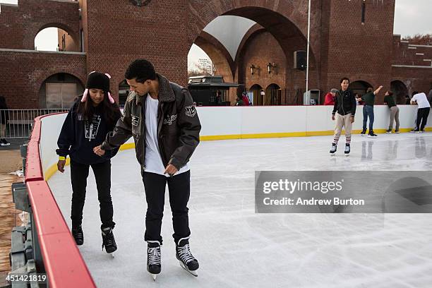 People hold hands while ice skating at the ice rink at McCarren Pool, which opened for the winter months last week, on November 22, 2013 in the Green...