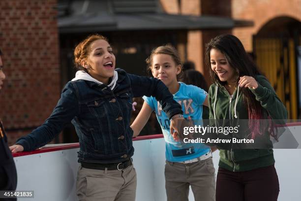 Girls laugh while ice skating at the ice rink at McCarren Pool, which opened for the winter months last week, on November 22, 2013 in the Green Point...