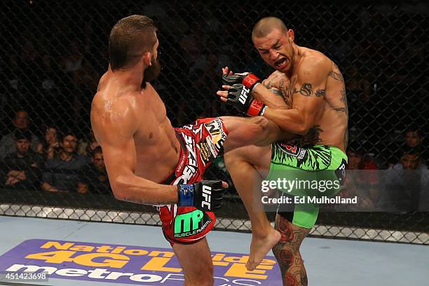 Jeremy Stephens kicks Cub Swanson in their featherweight bout at the AT&T Center on June 28, 2014 in San Antonio, Texas.