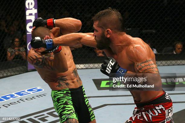 Jeremy Stephens punches Cub Swanson in their featherweight bout at the AT&T Center on June 28, 2014 in San Antonio, Texas.