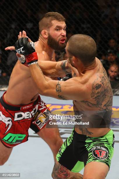 Jeremy Stephens punches Cub Swanson in their featherweight bout at the AT&T Center on June 28, 2014 in San Antonio, Texas.