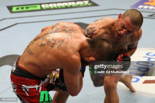 Cub Swanson punches Jeremy Stephens in their featherweight bout at the AT&T Center on June 28, 2014 in San Antonio, Texas.