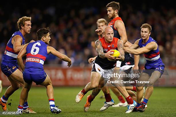 Nathan Jones of the Demons runs with the ball during the round 15 AFL match between the Western Bulldogs and the Melbourne Demons at Etihad Stadium...