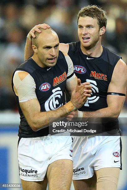 Chris Judd of the Blues celebrates a goal with Lachie Henderson of the Blues during the round 15 AFL match between the Collingwood Magpies and the...