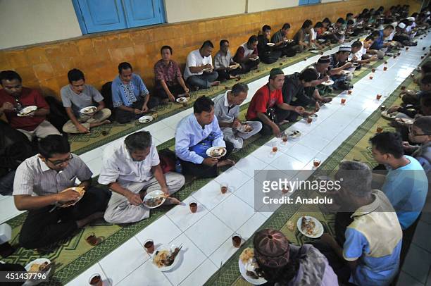 Muslims break their fast at the Grand Mosque in Solo, Central Java, Indonesia, on June 29, 2014. Every day during the holy month Ramadan, board of...