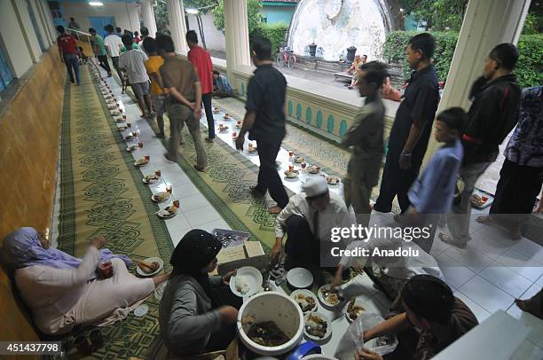 Muslims break their fast at the Grand Mosque in Solo, Central Java, Indonesia, on June 29, 2014. Every day during the holy month Ramadan, board of...