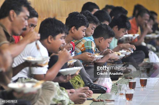 Muslims break their fast at the Grand Mosque in Solo, Central Java, Indonesia, on June 29, 2014. Every day during the holy month Ramadan, board of...