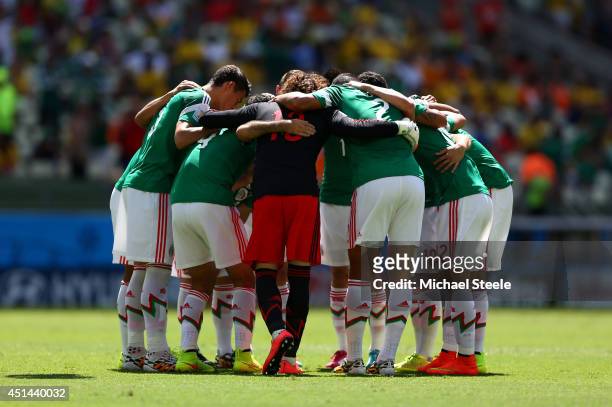 Mexico players huddle on the pitch prior to the 2014 FIFA World Cup Brazil Round of 16 match between Netherlands and Mexico at Castelao on June 29,...