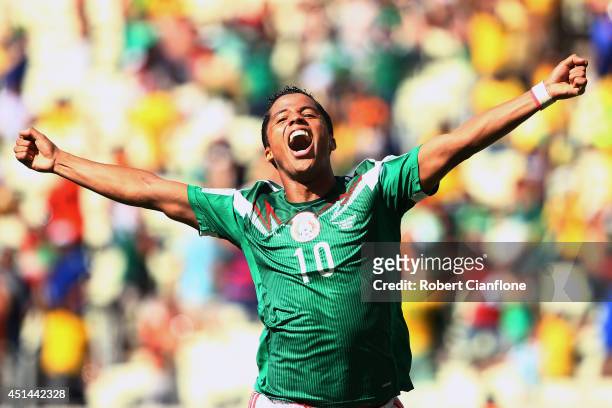 Giovani dos Santos of Mexico celebrates scoring his team's first goal during the 2014 FIFA World Cup Brazil Round of 16 match between Netherlands and...