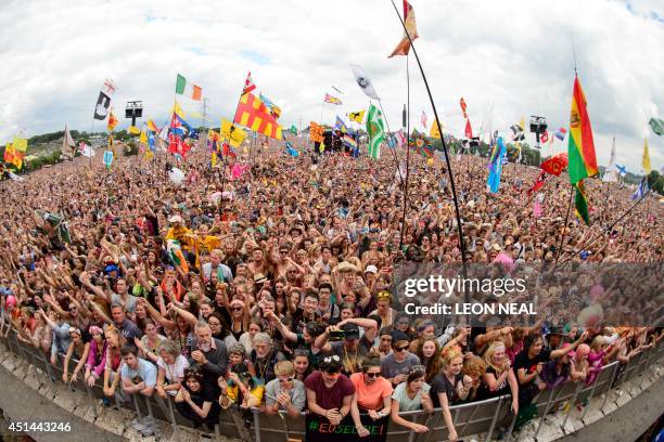 Fans enjoy the music as US singer Dolly Parton performs on the Pyramid Stage, on the final day of the Glastonbury Festival of Music and Performing...